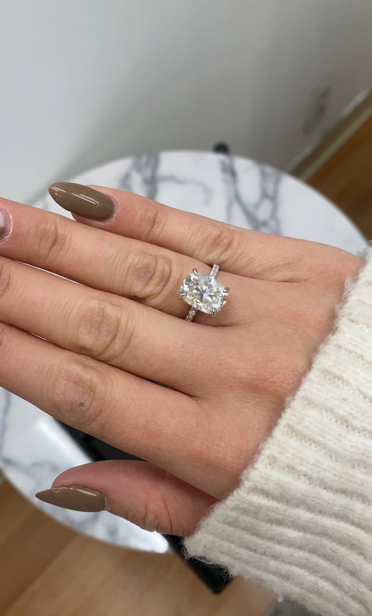 Elongated Cushion Cut Engagement Ring With Sidestones and Hidden Halo