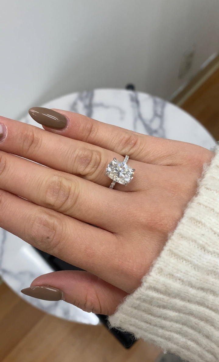 Elongated Cushion Cut Engagement Ring With Sidestones and Hidden Halo