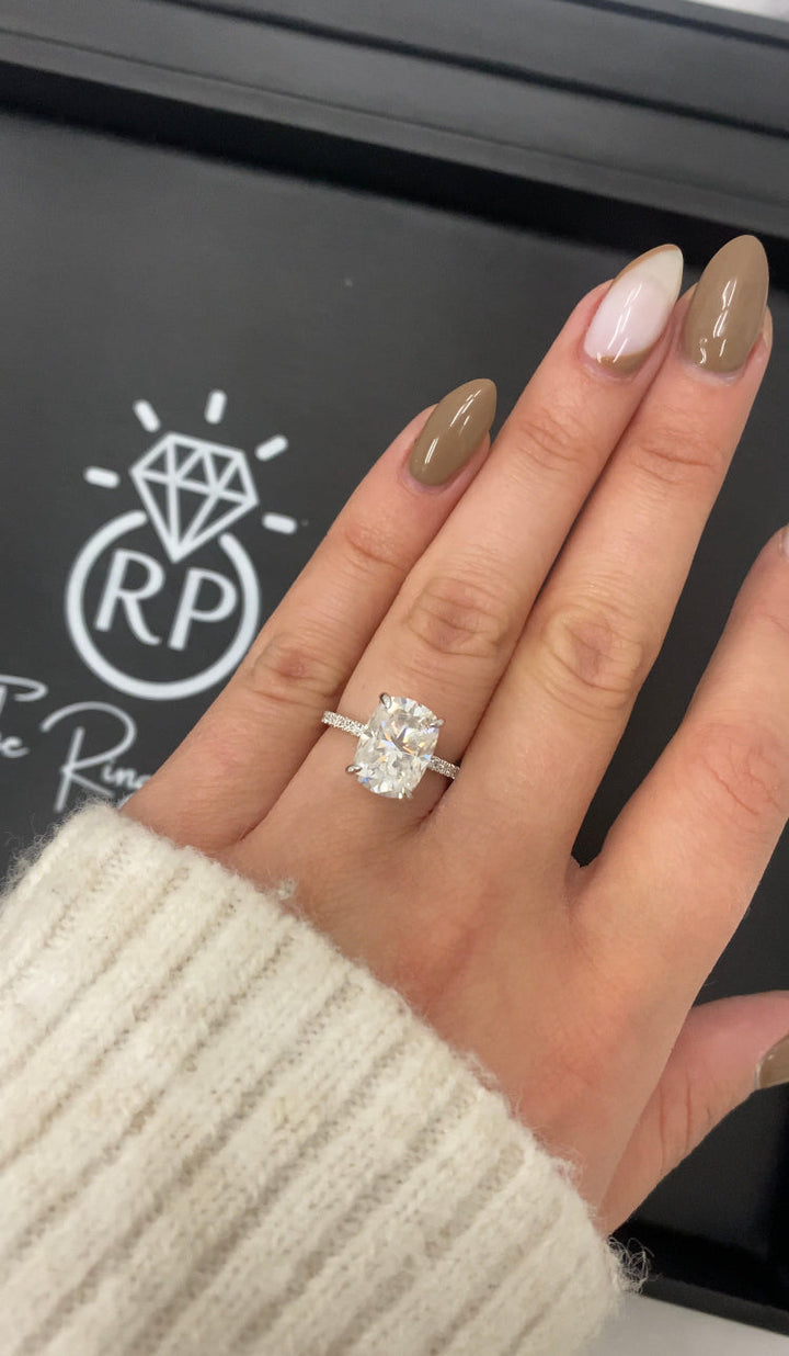 Elongated Cushion Cut Engagement Ring With Sidestones and Hidden Halo