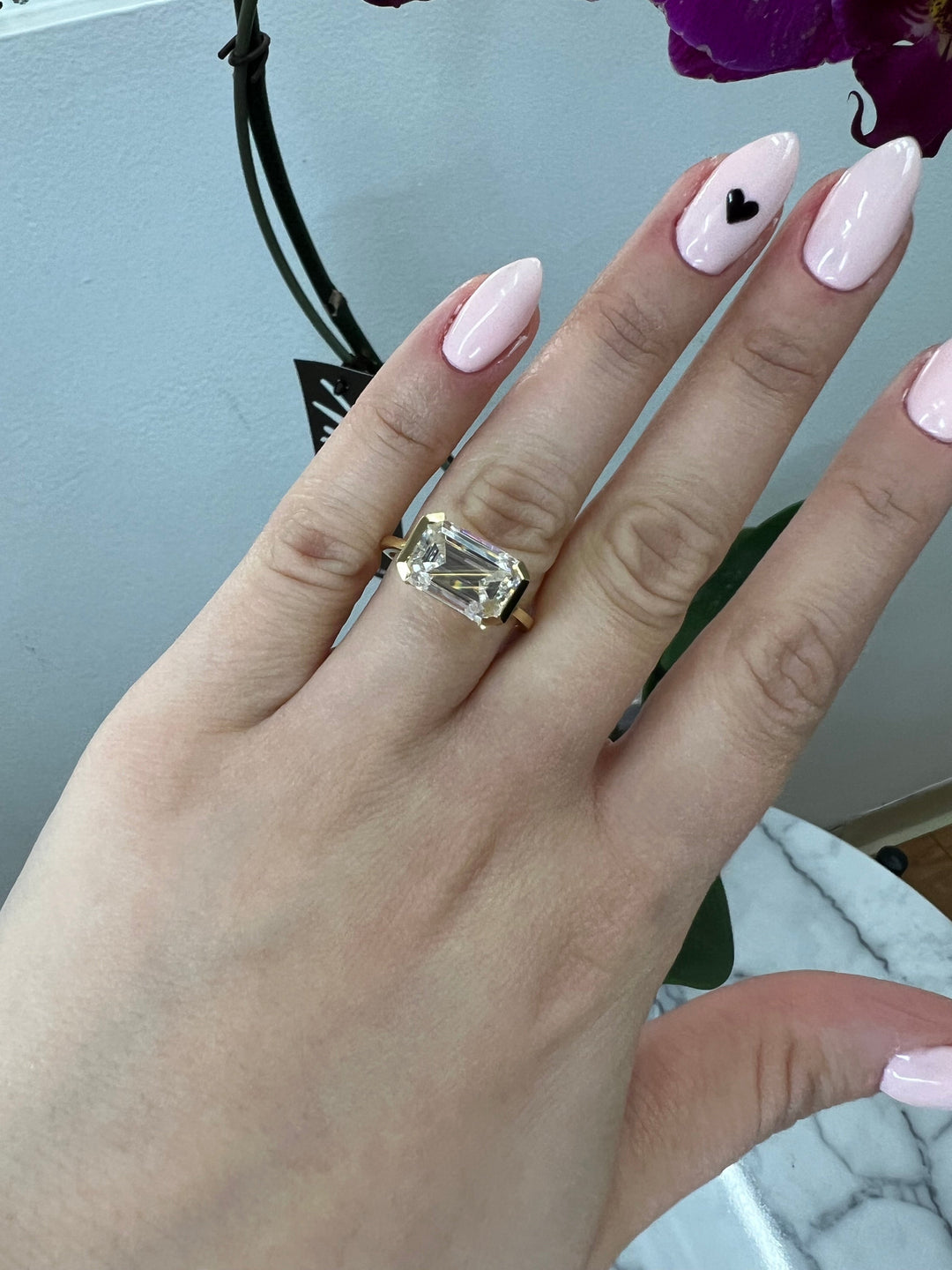 Bezel Set Emerald Cut Engagement Ring East to West