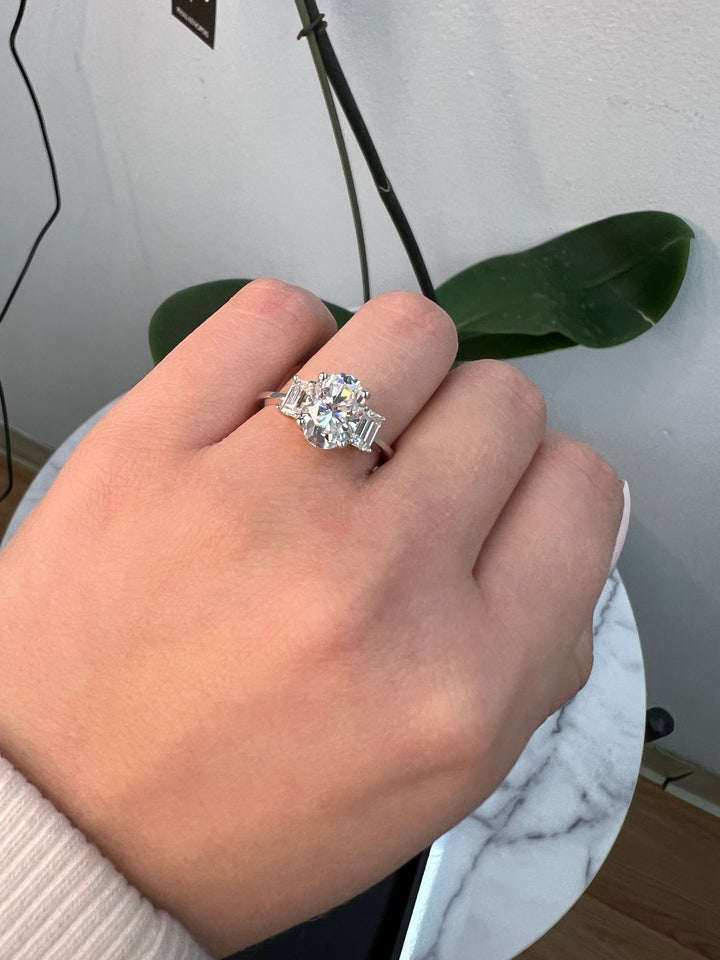 Oval Cut Engagement Ring with Emerald Side Stones