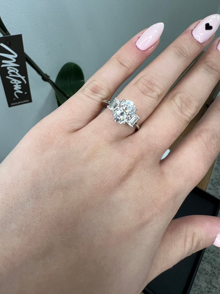 Oval Cut Engagement Ring with Emerald Side Stones
