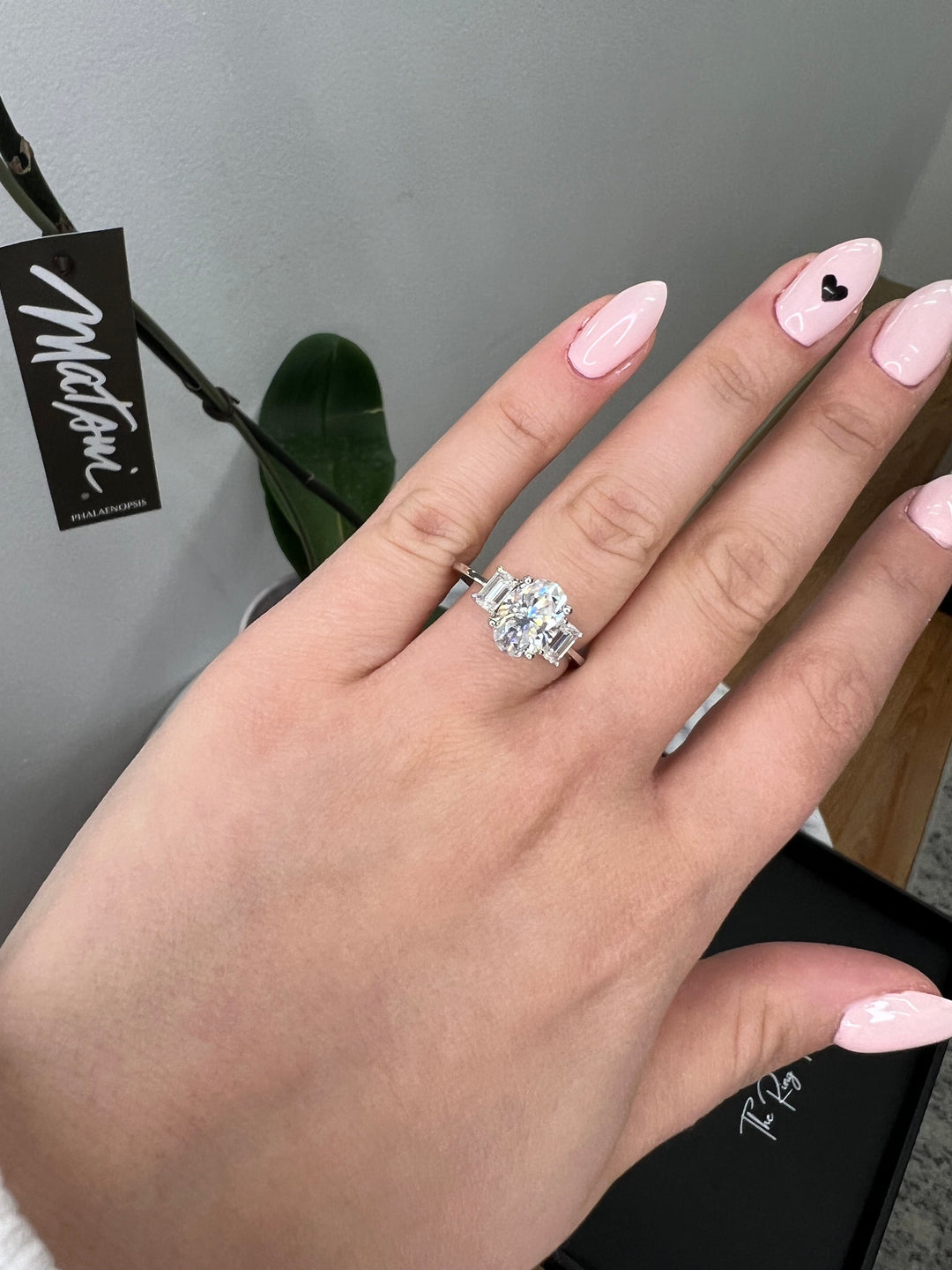Oval Cut Engagement Ring with Emerald Side Stones