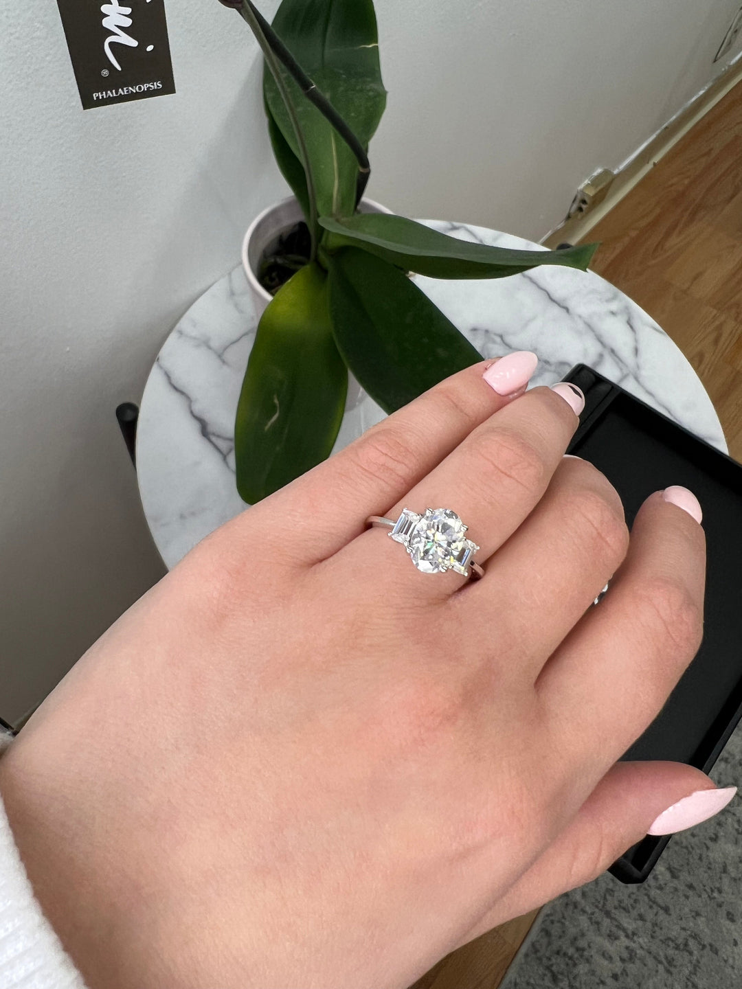 Oval Cut Engagement Ring with Emerald Side Stones
