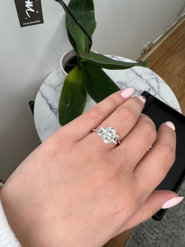 Oval Cut Engagement Ring with Emerald Side Stones