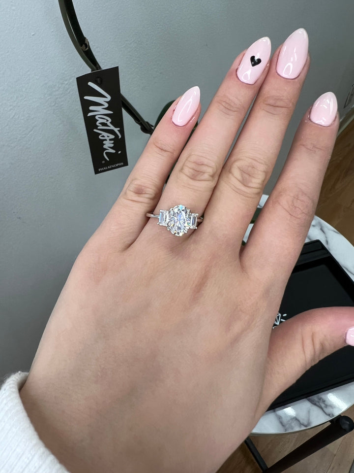 Oval Cut Engagement Ring with Emerald Side Stones