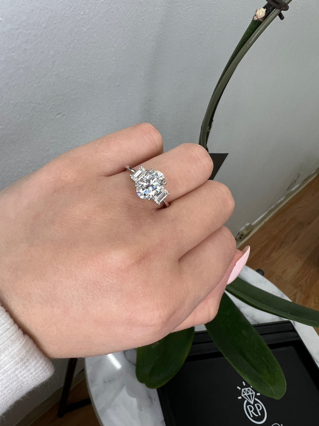 Oval Cut Engagement Ring with Emerald Side Stones