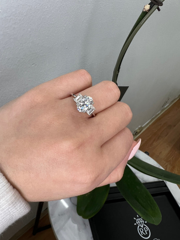 Oval Cut Engagement Ring with Emerald Side Stones