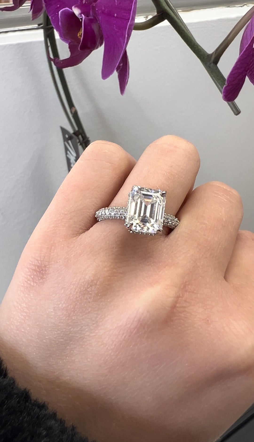 Emerald Cut Engagement Ring with Sidestones and Hidden Halo