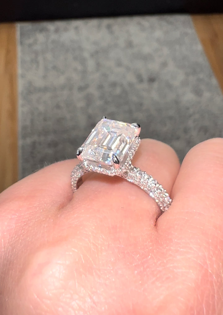 Emerald Cut Engagement Ring with Sidestones and Hidden Halo